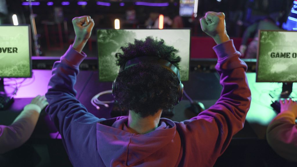 Cybersecurity event participant capturing a flag and raising their arms in glory